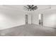 Bright bedroom featuring neutral carpet, tray ceilings, and easy access to the en-suite bathroom and walk-in closet at 5421 Landing Place Ln, Noblesville, IN 46062