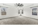 Spacious bedroom with tray ceilings, neutral carpet, and ample natural light from three windows at 5421 Landing Place Ln, Noblesville, IN 46062
