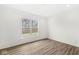 Empty bedroom featuring hardwood flooring, a large window, and white walls at 5421 Landing Place Ln, Noblesville, IN 46062