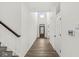 Welcoming hallway with wood floors, bright white walls, and a stylish front door at 5421 Landing Place Ln, Noblesville, IN 46062