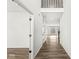 Bright hallway with wood floors, white walls, and an open view into the living area at 5421 Landing Place Ln, Noblesville, IN 46062