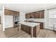 Kitchen features an island, stainless appliances, and wood-look flooring at 5421 Landing Place Ln, Noblesville, IN 46062