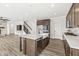 Open kitchen boasts a kitchen island with a sink and stainless steel appliances at 5421 Landing Place Ln, Noblesville, IN 46062