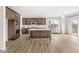 Modern kitchen with stainless steel appliances, large island, and wood flooring at 5421 Landing Place Ln, Noblesville, IN 46062
