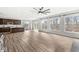 Spacious living room with hardwood floors, bright light, and modern kitchen in background at 5421 Landing Place Ln, Noblesville, IN 46062