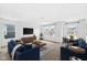 Comfortable living room with plush blue seating, entertainment center, and ample natural light at 5421 Landing Place Ln, Noblesville, IN 46062