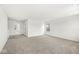 Large, open living room area with neutral carpet, white walls, and natural light at 5421 Landing Place Ln, Noblesville, IN 46062