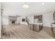 Open floorplan showcasing living room with stone fireplace and kitchen with island sink at 5421 Landing Place Ln, Noblesville, IN 46062