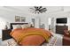 Spacious main bedroom with ceiling fan, sitting area, ensuite bathroom, and decorative rug at 5421 Landing Place Ln, Noblesville, IN 46062