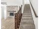 Staircase with carpeted steps and a wood railing, leading to the upper level at 5421 Landing Place Ln, Noblesville, IN 46062