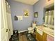 Bathroom with single vanity, updated flooring and shower/tub combo at 5451 Kelvington Ln, Indianapolis, IN 46254