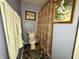 Cozy bathroom with patterned shower curtain, decorative rug, and framed artwork at 5451 Kelvington Ln, Indianapolis, IN 46254