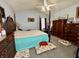 Comfortable bedroom featuring a four-poster bed, carpeted floors, and wood furnishings at 5451 Kelvington Ln, Indianapolis, IN 46254