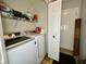Laundry area with washer, dryer, and storage shelves at 5451 Kelvington Ln, Indianapolis, IN 46254