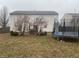 Large grassy backyard with a trampoline and patio with a table set at 5801 Safari Dr, Indianapolis, IN 46237