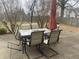 Backyard with patio, and a neutral colored patio table and chairs with an umbrella at 5801 Safari Dr, Indianapolis, IN 46237