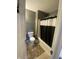 This bathroom features a shower/tub combination and a grey accent wall at 5801 Safari Dr, Indianapolis, IN 46237