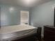 Bedroom featuring neutral walls, simple window treatments, and a dark wood bedroom set at 5801 Safari Dr, Indianapolis, IN 46237