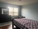 Bright bedroom with hardwood floors, large window and a decorative bedroom set at 5801 Safari Dr, Indianapolis, IN 46237