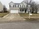 Two story home with a two car garage, a small front porch, and a driveway at 5801 Safari Dr, Indianapolis, IN 46237