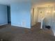 Upstairs hallway featuring neutral carpet, chandelier, and access to other rooms at 5801 Safari Dr, Indianapolis, IN 46237