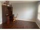Home office featuring dark wood floors, light blue walls, and a built-in desk at 5801 Safari Dr, Indianapolis, IN 46237