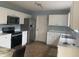 Bright kitchen with stainless steel appliances, white cabinets and tile floors at 5801 Safari Dr, Indianapolis, IN 46237