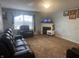 Spacious living room with dark leather furniture and a fireplace at 5801 Safari Dr, Indianapolis, IN 46237
