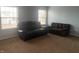 A large living room with carpet, two couches, and lots of natural light at 5801 Safari Dr, Indianapolis, IN 46237