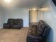 Spacious living room featuring two comfortable leather sofas and neutral carpet at 5801 Safari Dr, Indianapolis, IN 46237