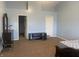 Large bedroom with carpet, a bed, and multiple entrances to other rooms at 5801 Safari Dr, Indianapolis, IN 46237