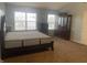 Spacious bedroom featuring carpet, a king bed, and a built-in cabinet at 5801 Safari Dr, Indianapolis, IN 46237
