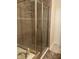 A recently remodeled bathroom shower with tan tile and a glass door at 5801 Safari Dr, Indianapolis, IN 46237