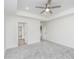 Airy bedroom boasts neutral carpet, tray ceiling, and access to a walk-in closet and bathroom at 5862 Harbour Town Dr, Noblesville, IN 46062