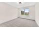 Bright bedroom featuring neutral walls, plush carpet, and a window with a serene view at 5862 Harbour Town Dr, Noblesville, IN 46062