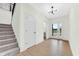Bright entryway with hardwood floors, staircase, and a glass door providing natural light and backyard views at 5862 Harbour Town Dr, Noblesville, IN 46062