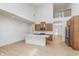 Open kitchen with high ceilings, wooden cabinets, stainless steel refrigerator, and lots of space at 5862 Harbour Town Dr, Noblesville, IN 46062
