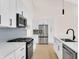 Modern kitchen with a large island, stainless steel appliances, and white cabinets at 5862 Harbour Town Dr, Noblesville, IN 46062