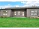 Lush green backyard with a well-maintained lawn, patio, and neutral colored siding at 5874 Harbour Town Dr, Noblesville, IN 46062