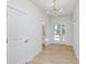 Bright entryway with wood floors, stairs, and a modern light fixture at 5874 Harbour Town Dr, Noblesville, IN 46062
