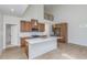 Modern kitchen with stainless steel appliances, white countertops, and wood cabinets, open floor plan at 5874 Harbour Town Dr, Noblesville, IN 46062