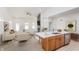 Open-concept living space with fireplace and kitchen island, perfect for entertaining and Gathering gatherings at 5874 Harbour Town Dr, Noblesville, IN 46062