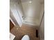 A bathroom with a shower-tub combo and sliding doors with ceramic tile flooring at 6533 Parker Ln, Indianapolis, IN 46220