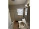 A bathroom with a shower-tub combo, a sink with a mirror, and a window to the backyard at 6533 Parker Ln, Indianapolis, IN 46220