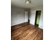 A bedroom with hardwood floors, closet and a butterfly decoration on the wall at 6533 Parker Ln, Indianapolis, IN 46220
