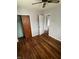 A bedroom featuring hardwood floors, ceiling fan and doors at 6533 Parker Ln, Indianapolis, IN 46220