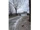 A single-Gathering home with a two-car garage and a long driveway on an overcast day at 6533 Parker Ln, Indianapolis, IN 46220