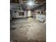 Unfinished garage space with exposed ceiling and concrete floors, showing water heater, and renovation potential at 6533 Parker Ln, Indianapolis, IN 46220