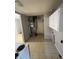 Features a kitchen with white cabinets, vintage appliances, and access to other rooms. Requires Renovation at 6533 Parker Ln, Indianapolis, IN 46220