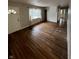 An open-concept living room featuring hardwood floors, natural light, and access to other rooms. Requires Renovation at 6533 Parker Ln, Indianapolis, IN 46220